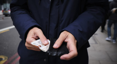 man putting in or taking off money from his wallet