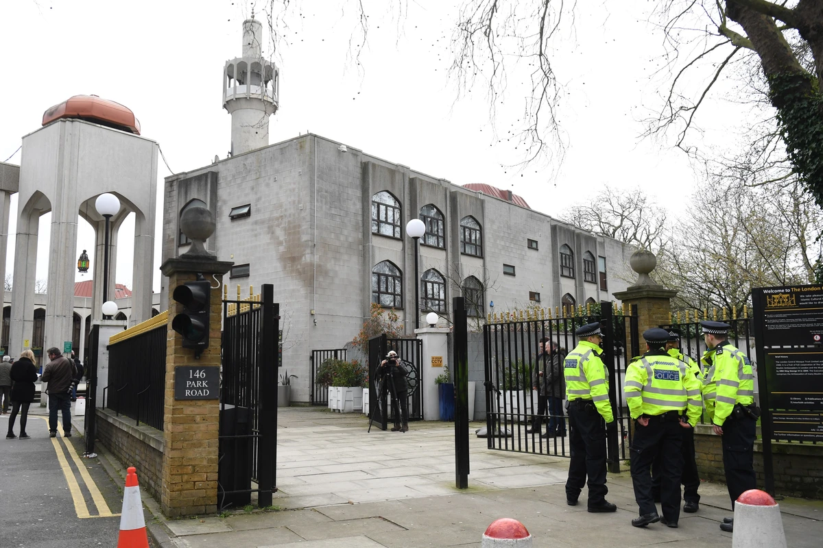 Exterior of a worship place with police officers ensuring security, highlighting safety measures for places of worship.