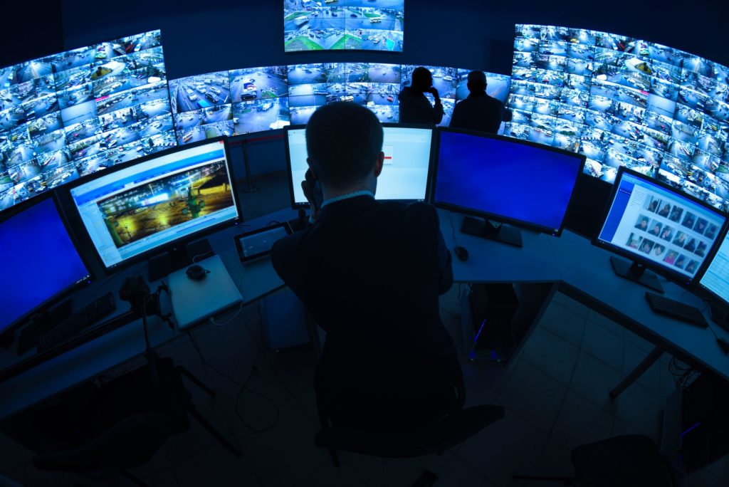 Security officer monitoring CCTV systems.