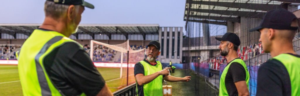 Security team coordinating at a stadium event, ensuring a safe environment for attendees.