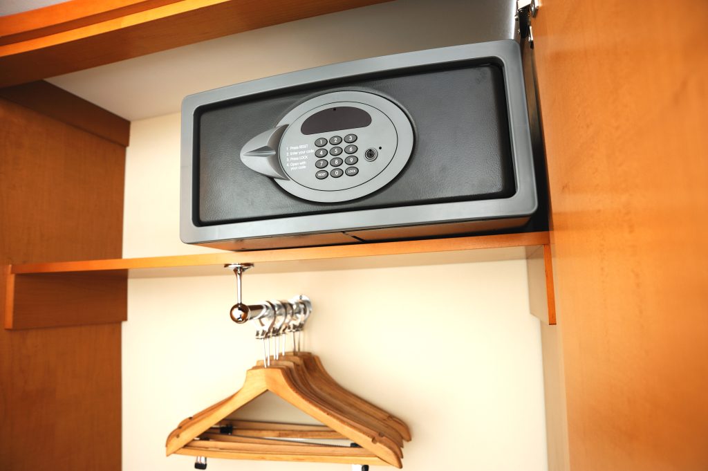 Hotel room wardrobe with a secure safe for storing valuables, highlighting essential hotel safety measures.