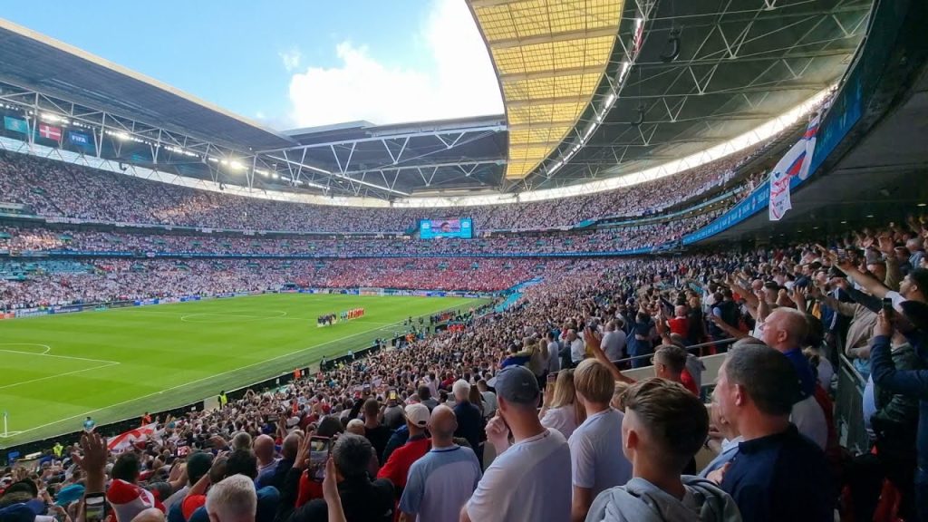 Crowding attending a sports match at Wembley Stadium