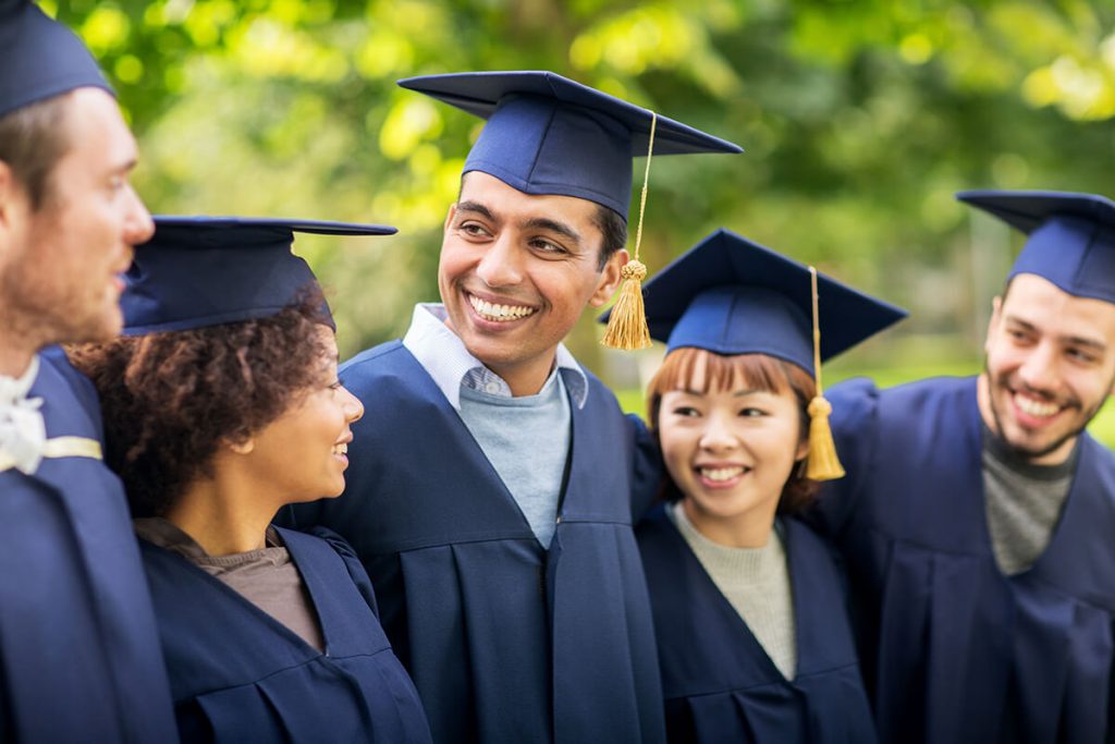 Group of international students celebrating their graduation, showcasing success and diversity in the UK higher education system.