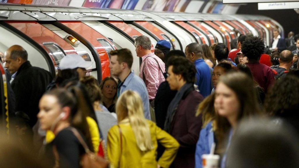 Busy Tube station during peak hours with a large crowd on the platform