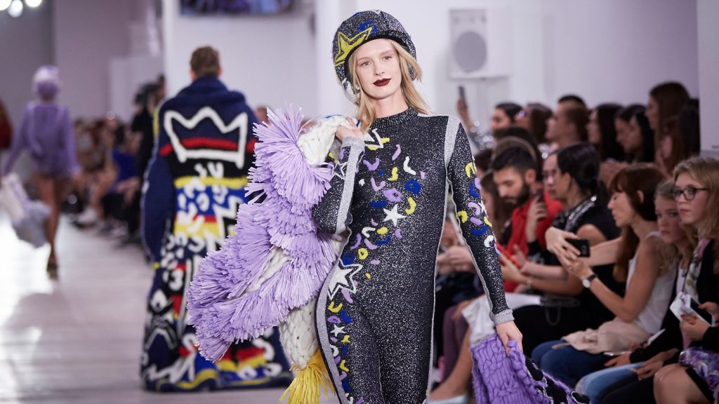 Model on the ramp at London Fashion Week, showcasing the event's fashion highlights 