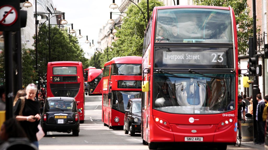 Iconic red London buses, a key mode of transport for attendees navigating London Fashion Week 2024 safely and efficiently.