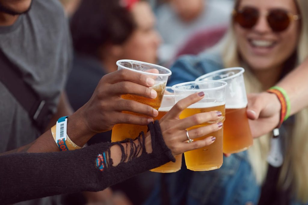 Group enjoying drinks together and staying safe at a music festival.