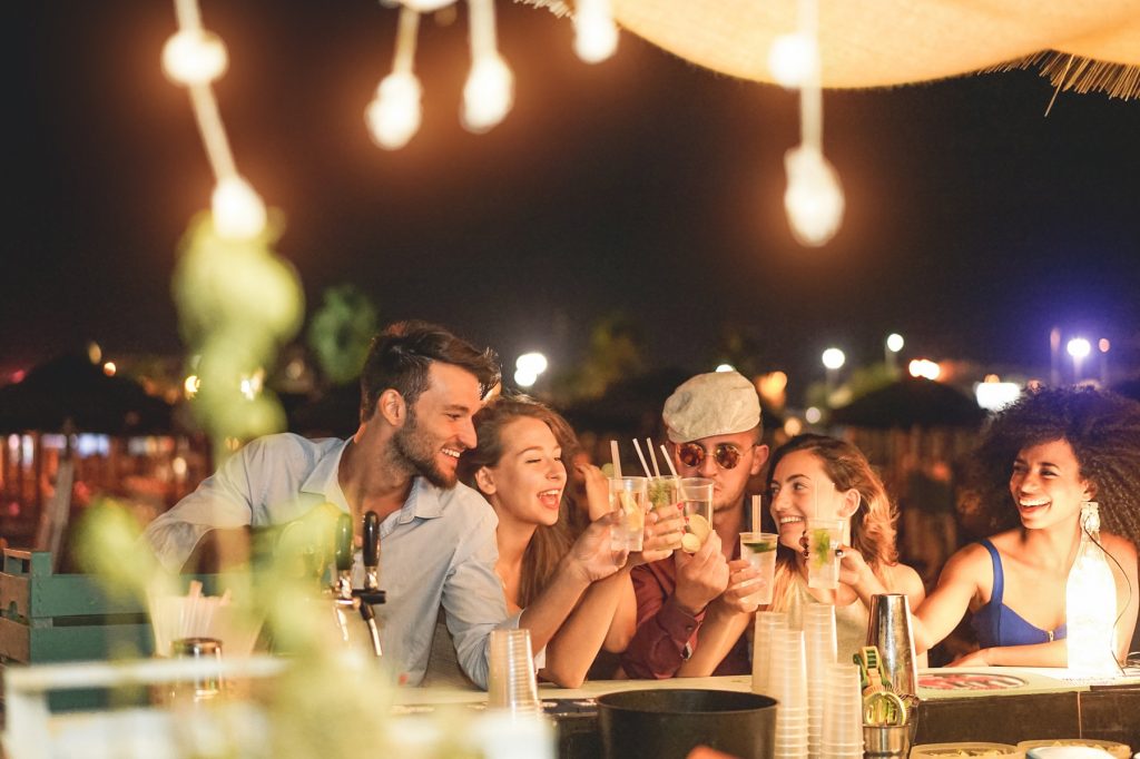 Group of friends enjoying drinks and having fun, staying safe during a night out in Manchester's vibrant nightlife.