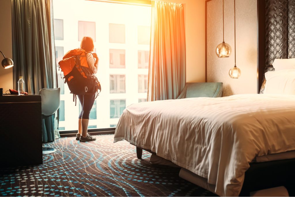 A solo female traveller verifying the security of her chosen accommodation for safety.