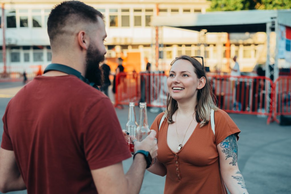 A man and woman enjoying drinks at a public venue.